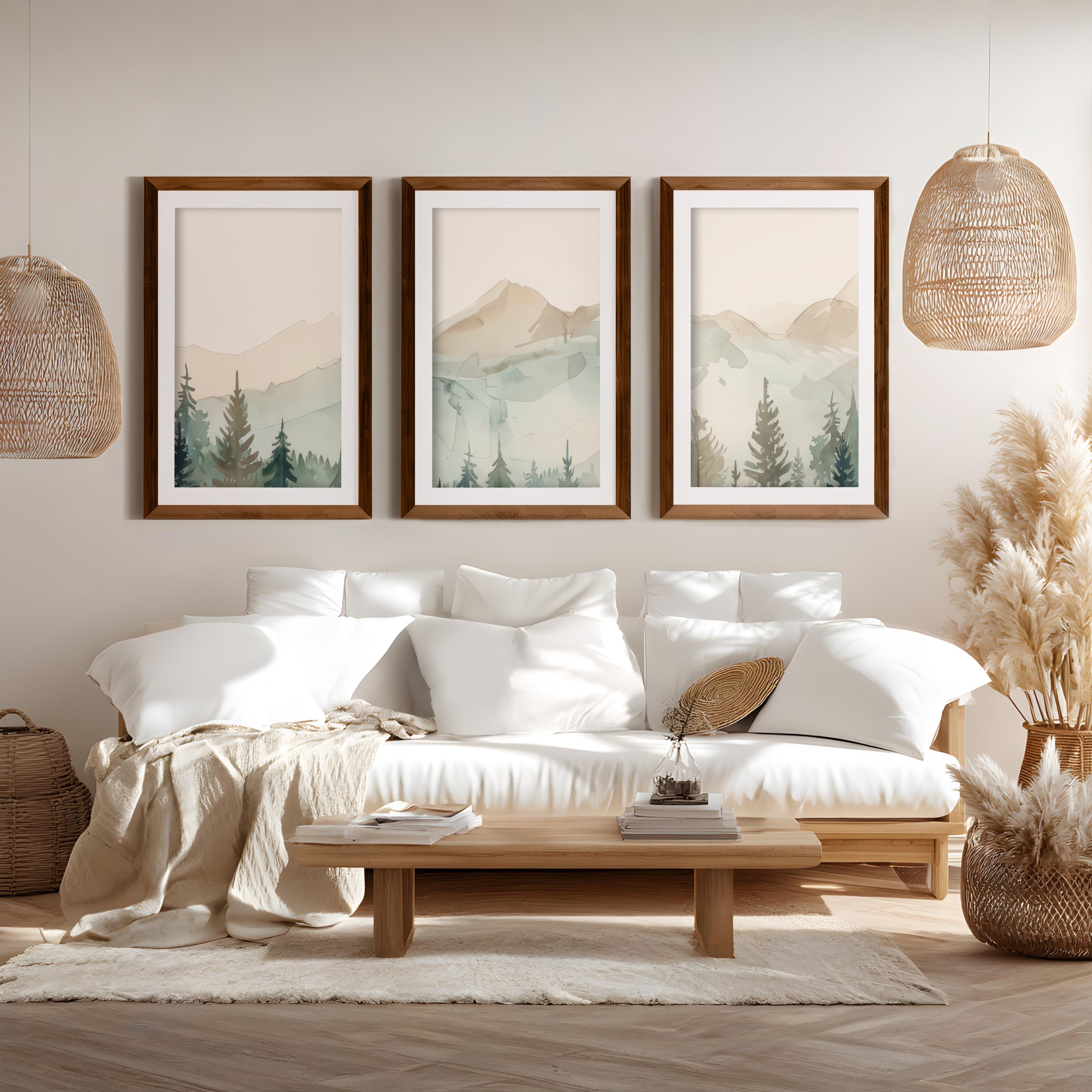 Watercolor triptych mountain scene art set with brown wood frames and white border in boho style living room