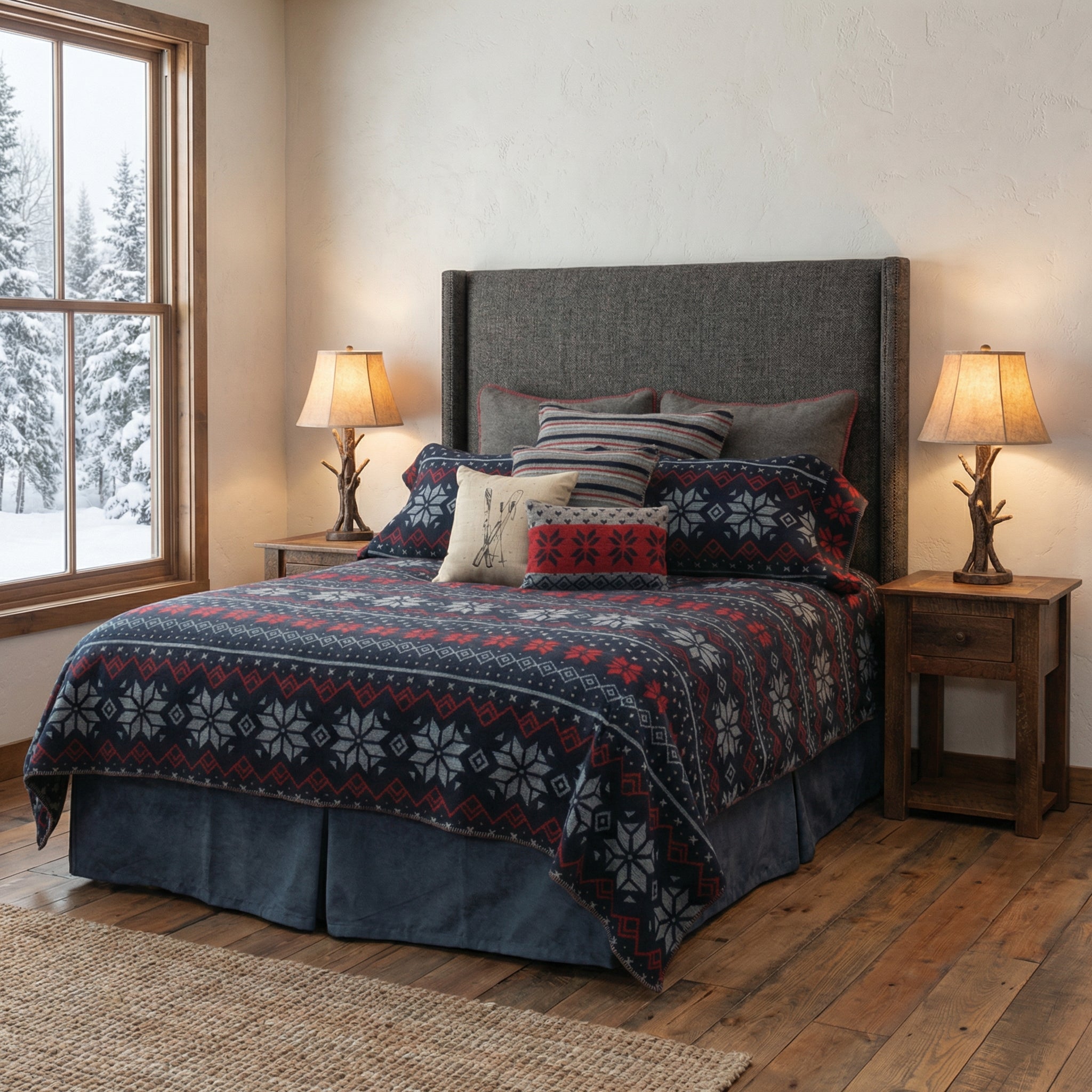 Nordic Winter Themed fabric on bedspread and pillow cases, and accent pillows. Deep blue with red patterens