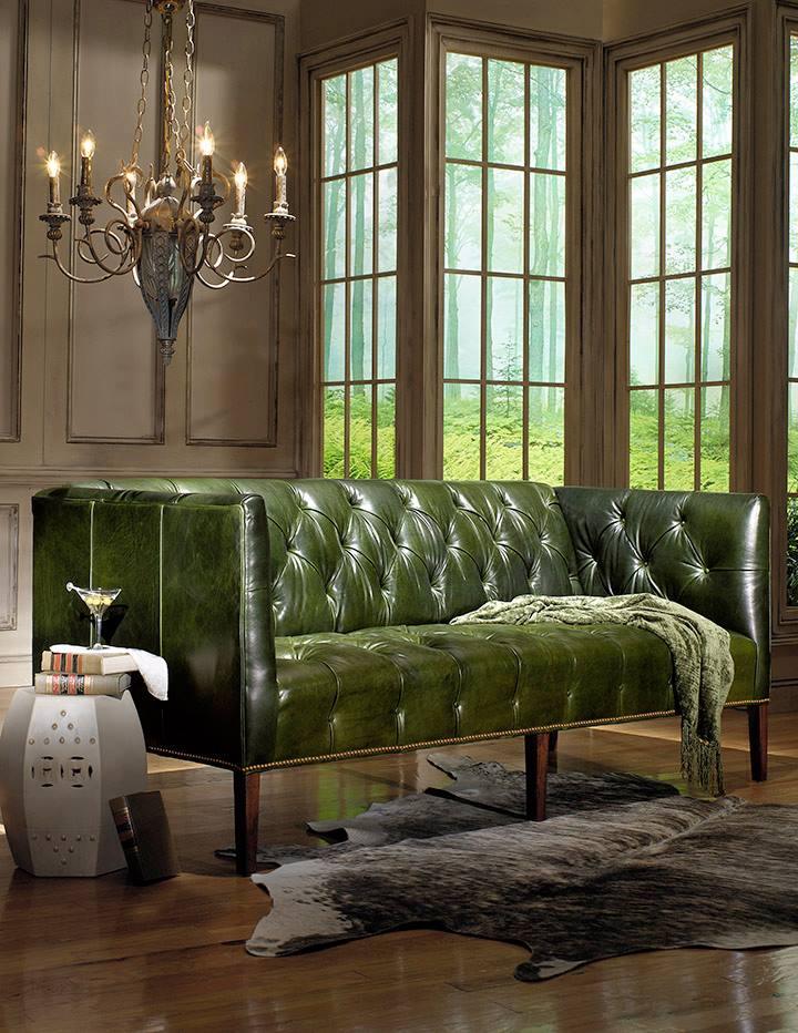 Green leather sofa in a room with large windows and a chandelier. Your Western Decor