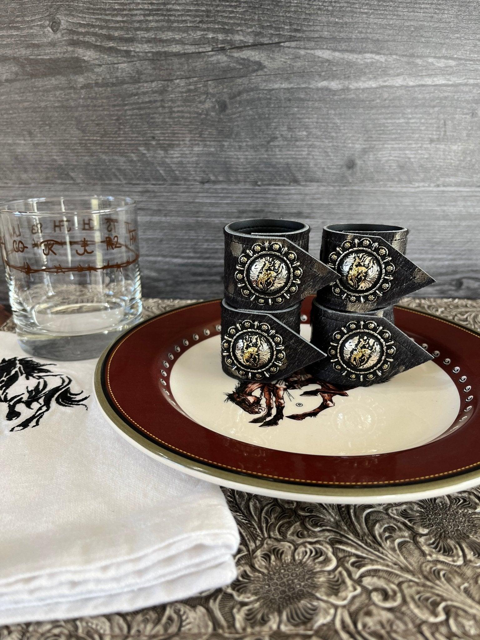 Pendleton Let er Buck cowhide napkin rings with bronc concho western rodeo table decor