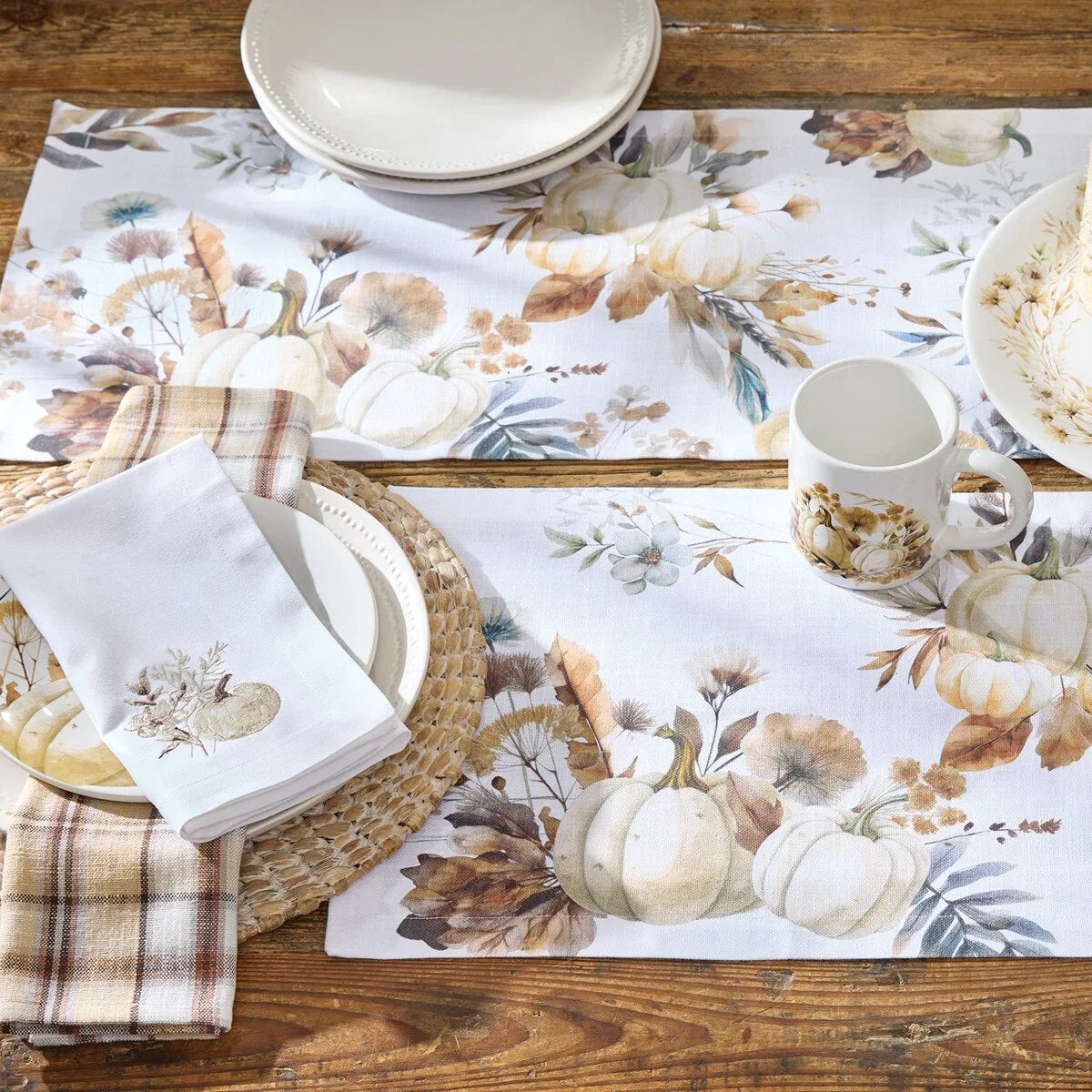 Table setting with floral and pumpkin-themed placemats, plates, and napkins on a wooden table - Your Western Decor