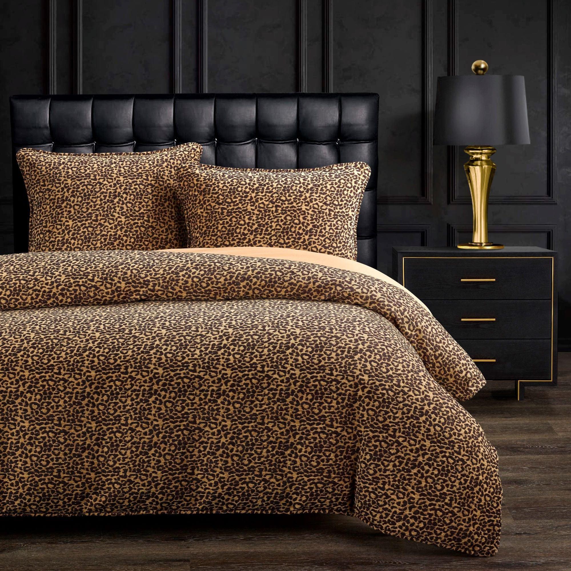 Bedroom with leopard print bedding, black upholstered headboard, and gold lamp - Your Western Decor