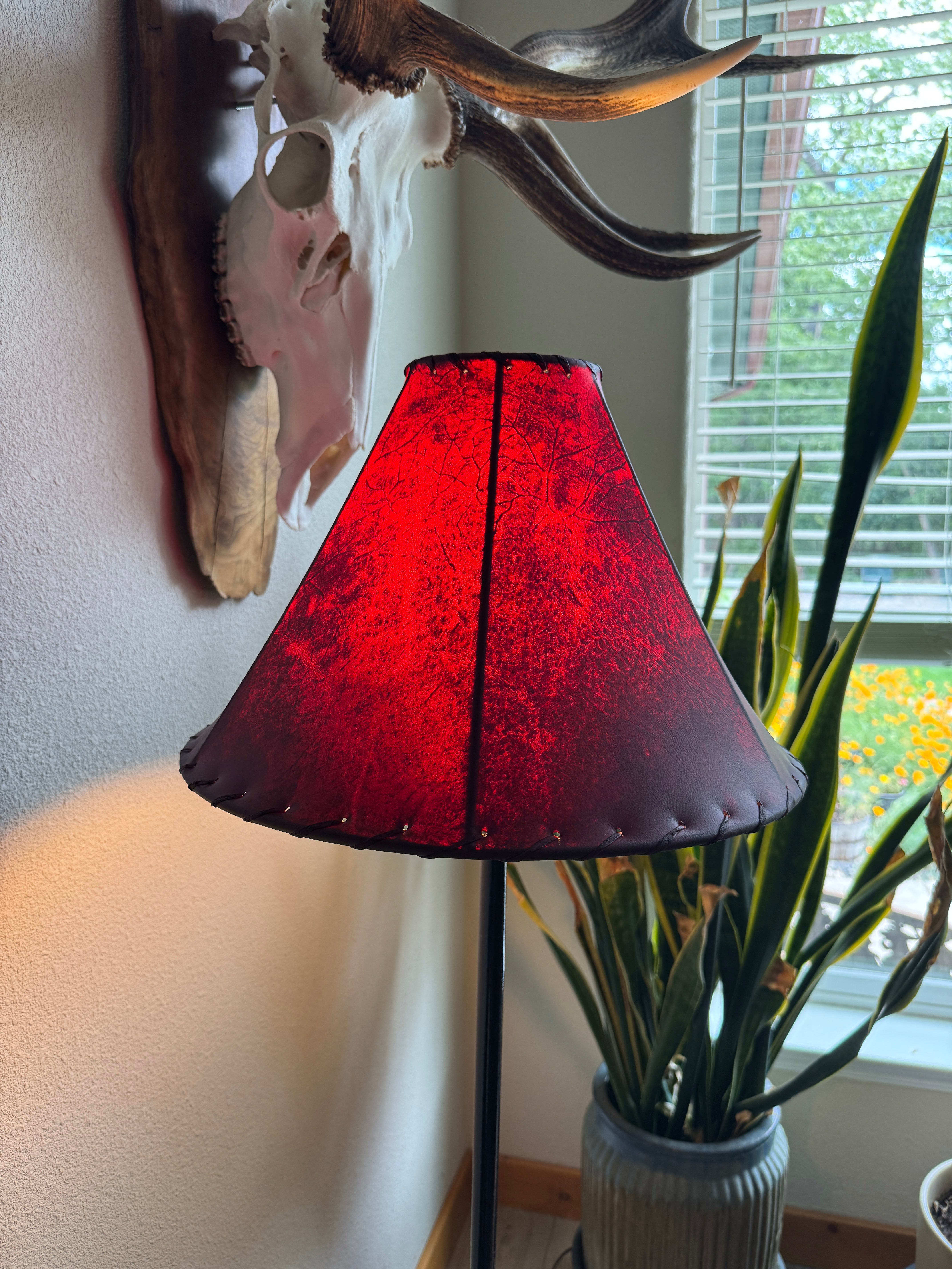 Red round 16 inch rawhide lamp shade with light on