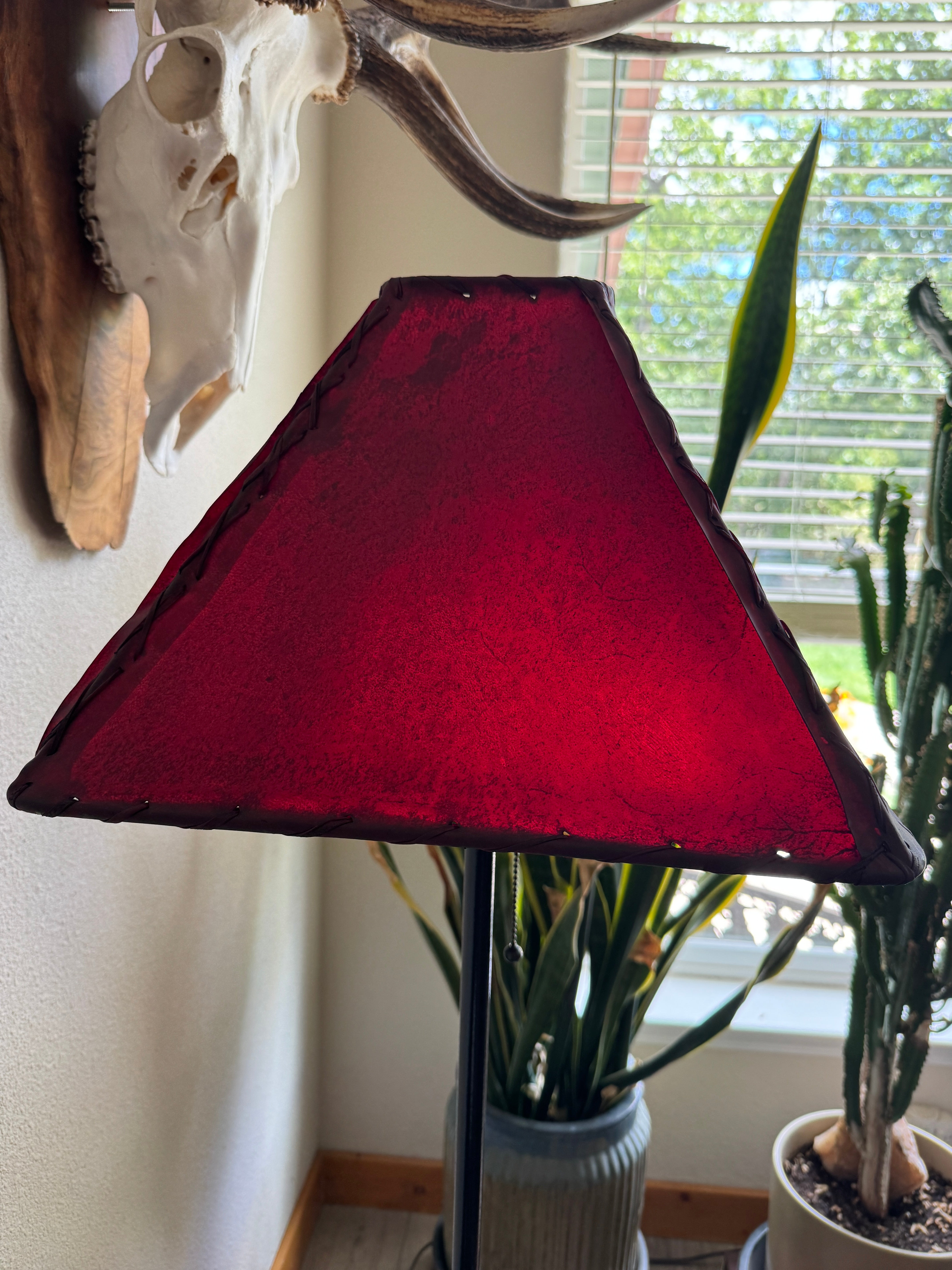Red square rawhide lamp shade light off natural lighting