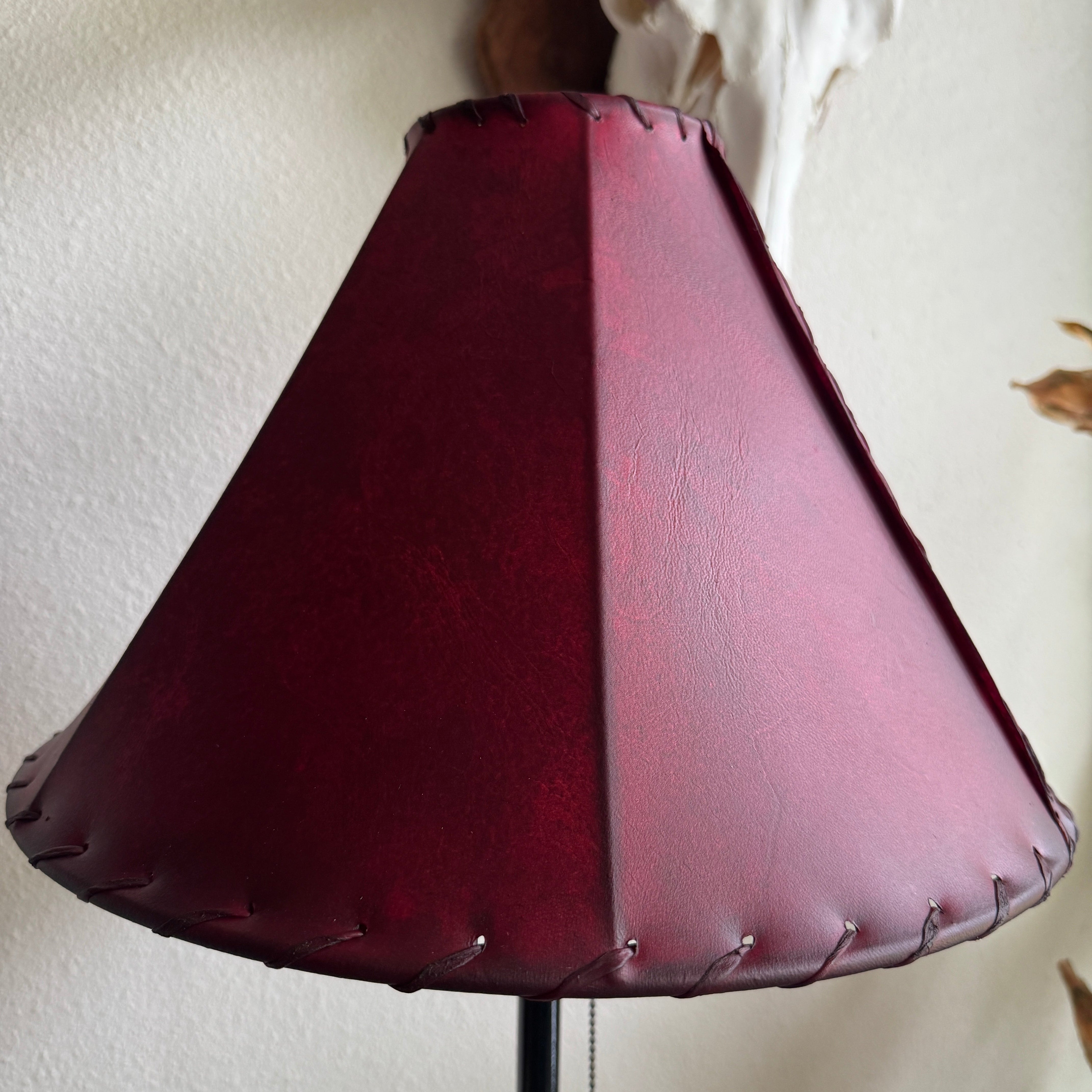 Round red leather lamp shade with whip stitch detail