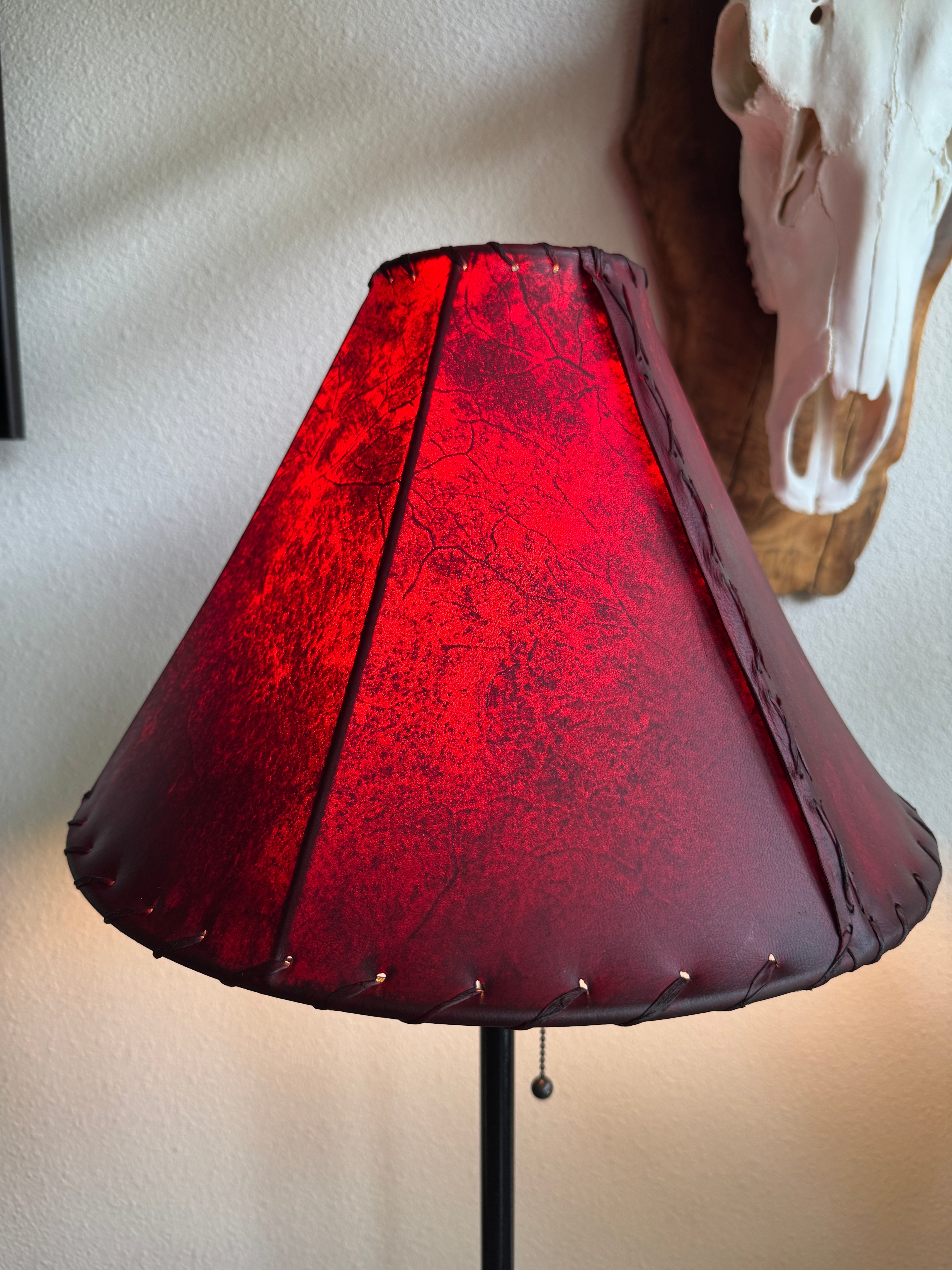 Red rawhide leather lamp shade with light on