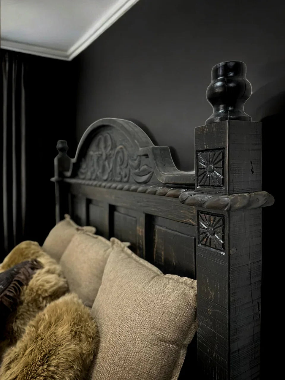 Decorative wooden headboard with intricate carvings and pillows in a room setting - YOur Western Decor