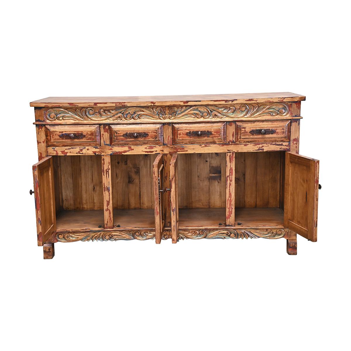 A rustic carved wooden sideboard cabinet with a distressed finish, featuring a top drawer section and two lower cabinet doors shown open to reveal the interior shelves, set against a plain white background.