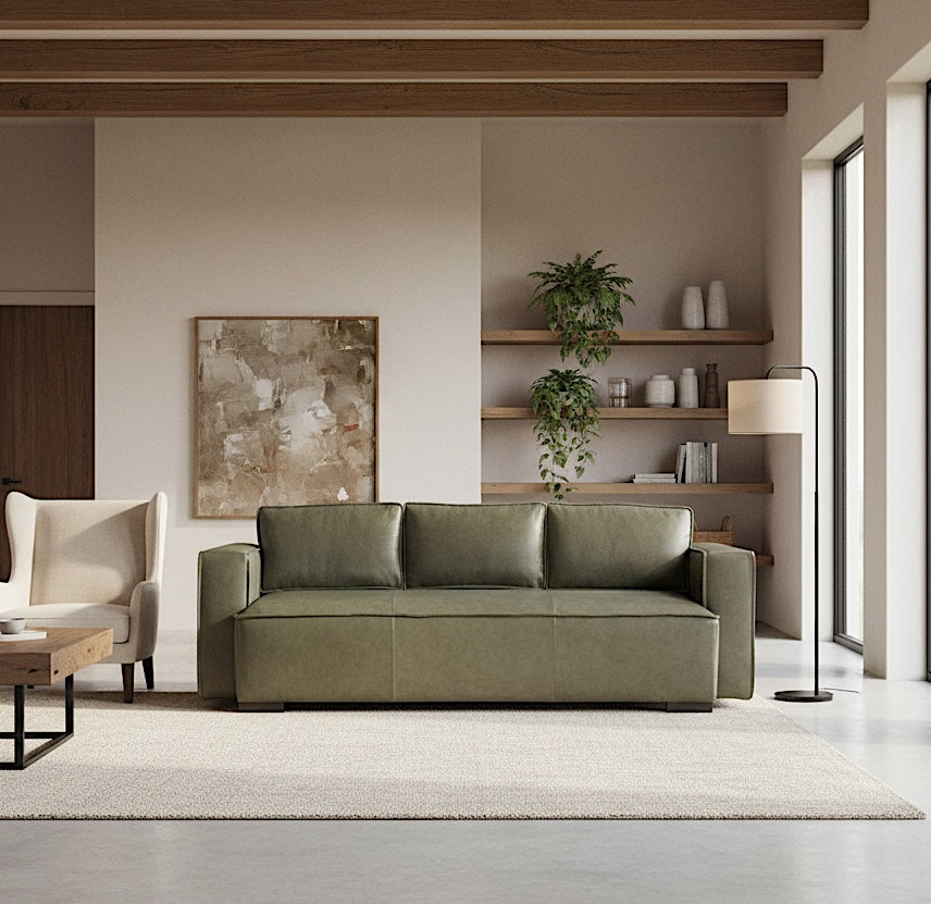 Modern living room with a green sofa, wooden shelves, and abstract art.
