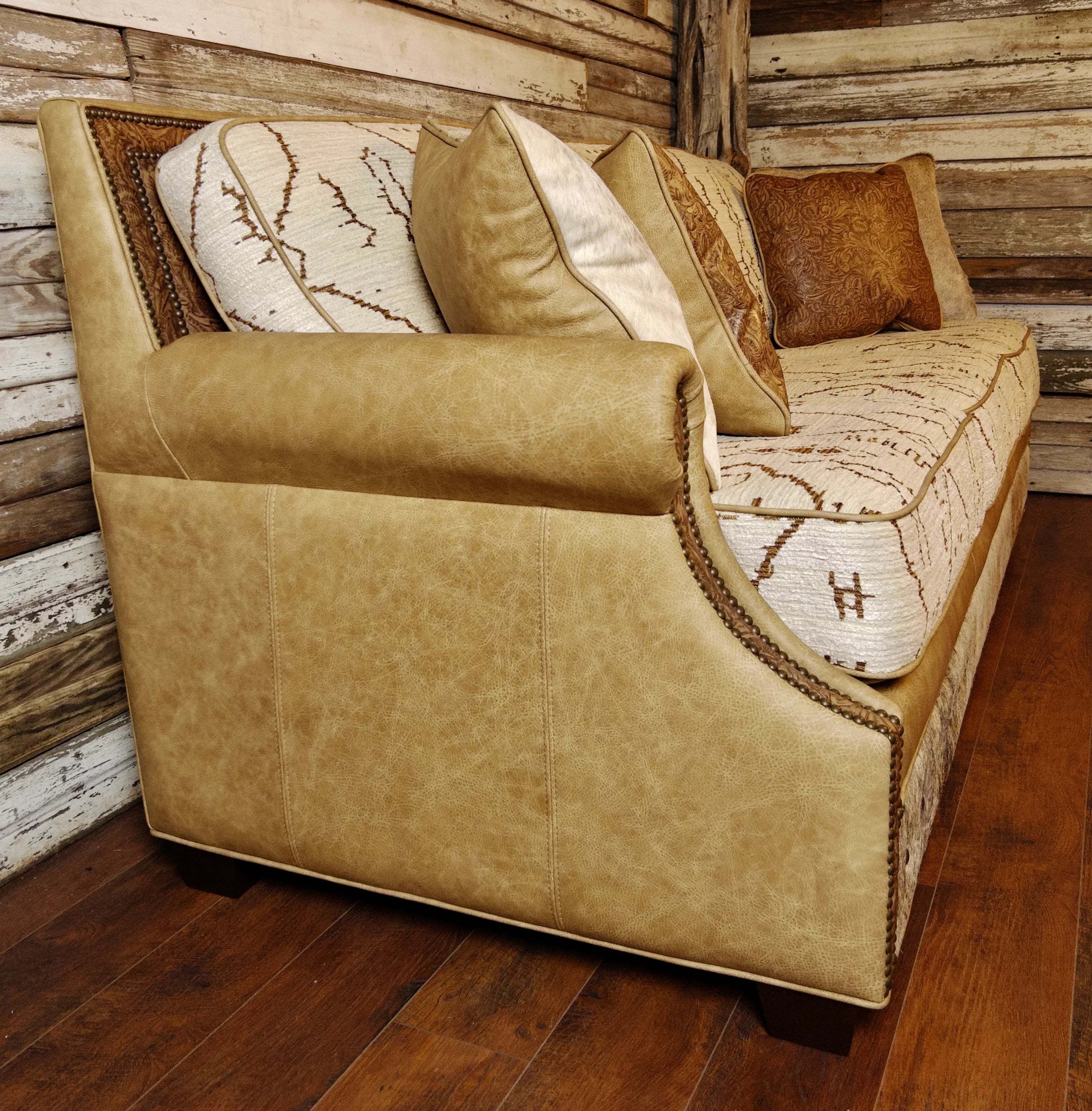 Side view of Mesa fabric and leather sofa with cowhide accents