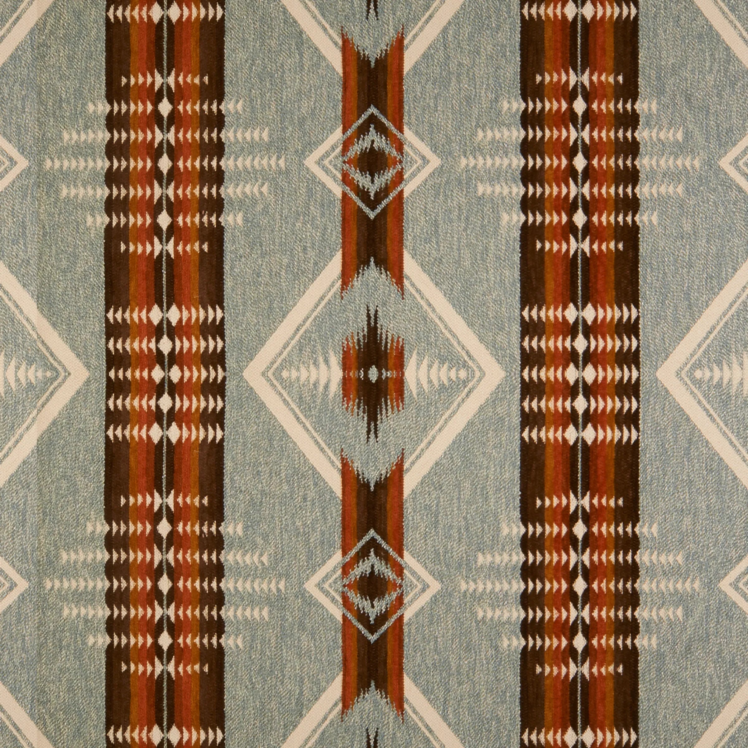 A close-up of a woven textile fabric pattern with a Southwestern geometric design. The color palette features a muted blue-gray base, vertical stripes in dark brown, rust red, and beige, and diamond motifs.