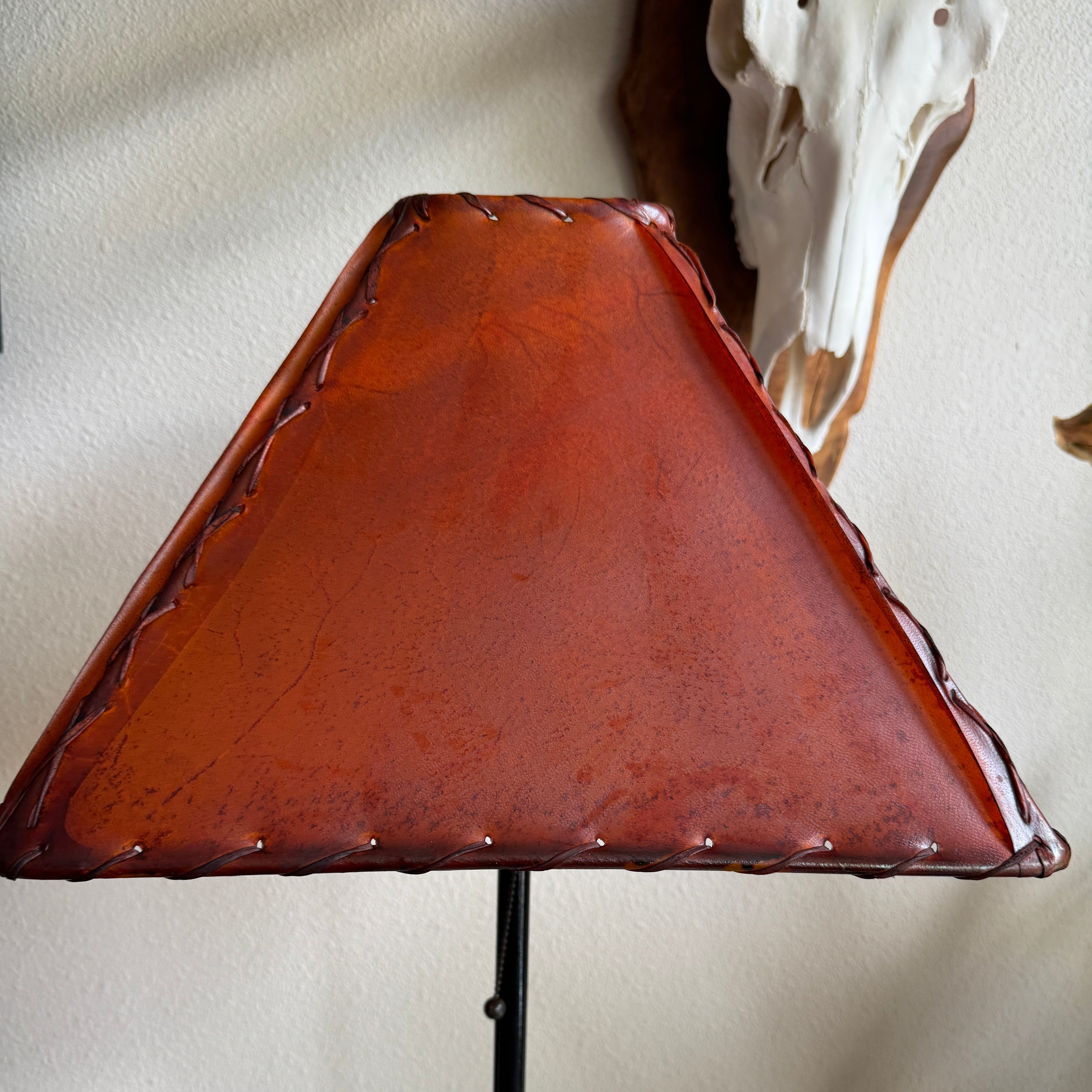 Square amber colored rawhide lamp shade with whip stitching