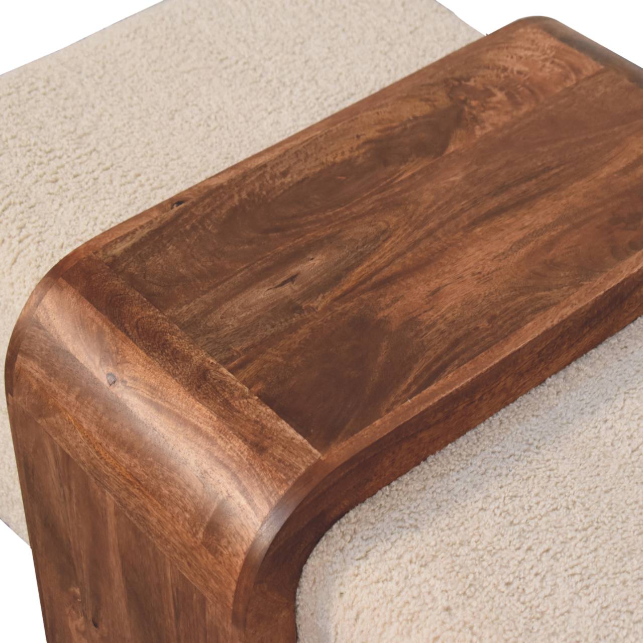 Close-up of the Stella Bouclé Cocktail Ottoman highlighting soft cream bouclé texture and richly grained solid mango wood.