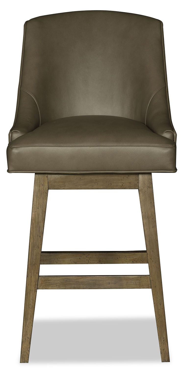 Brown leather bar stool with wooden legs on a white background