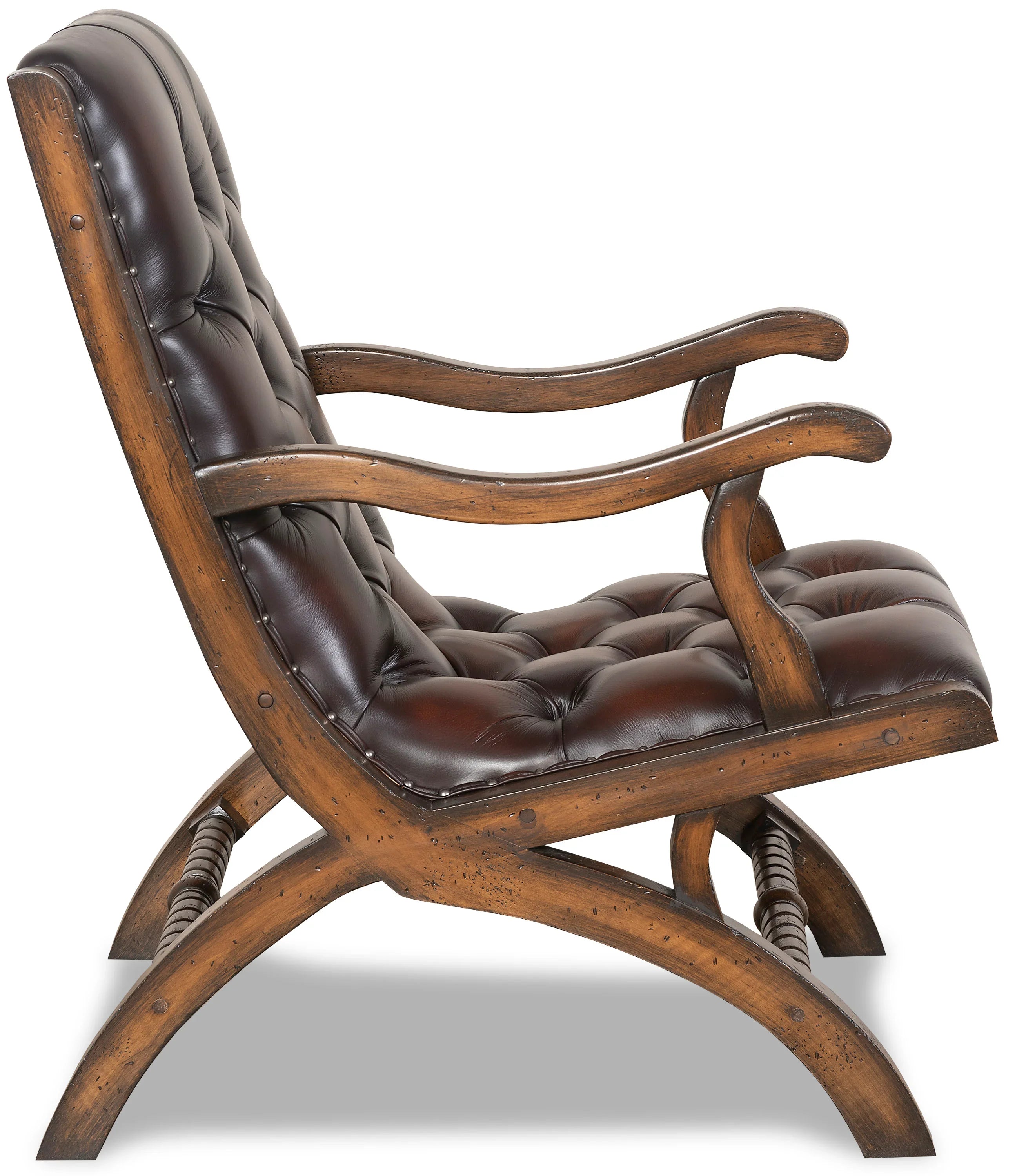 burnished leather tufted reading chair side view with nailhead trim and wood frame in western ranch office setting