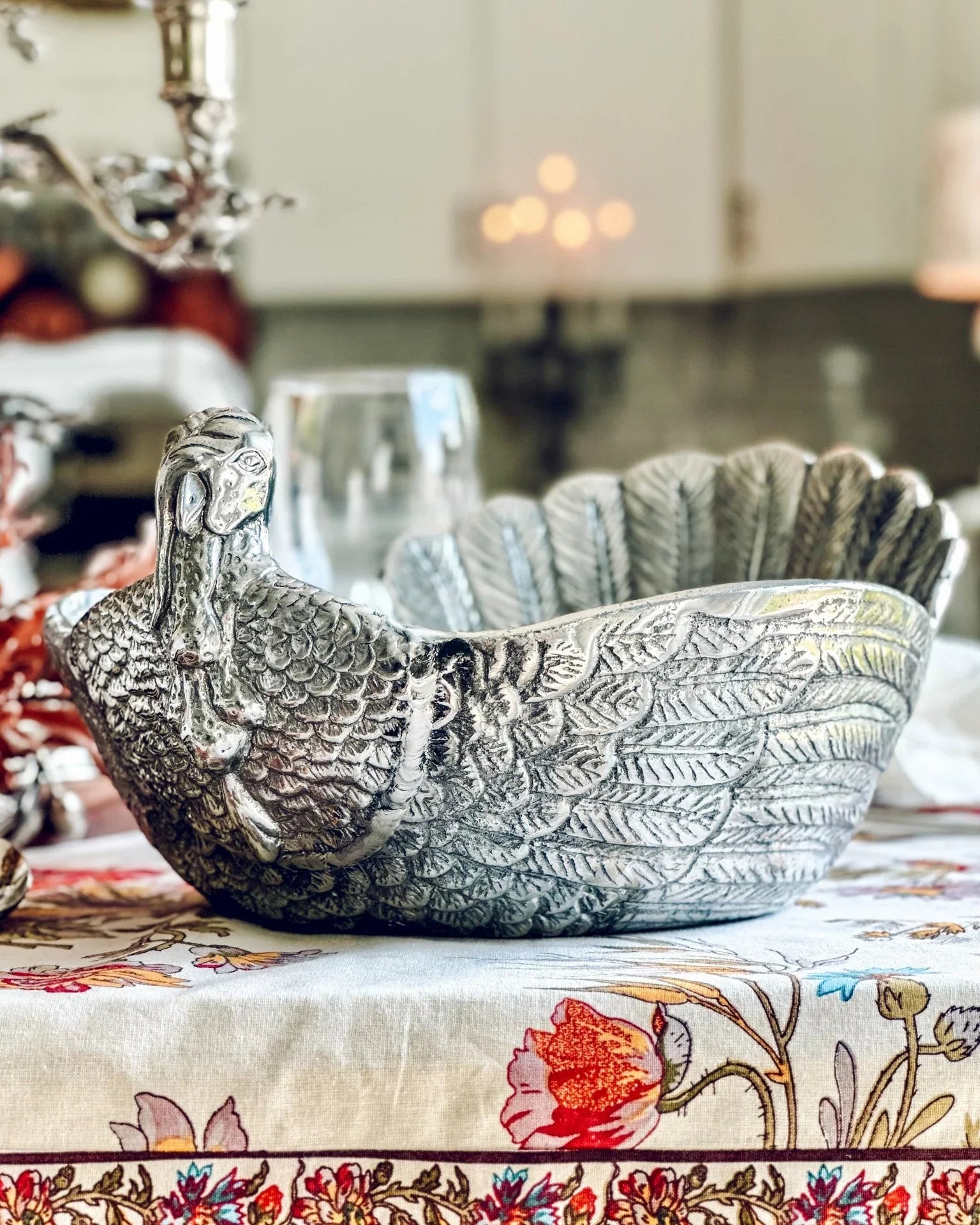 Decorative silver bowl shaped like a turkey on a floral tablecloth - Your Western Decor