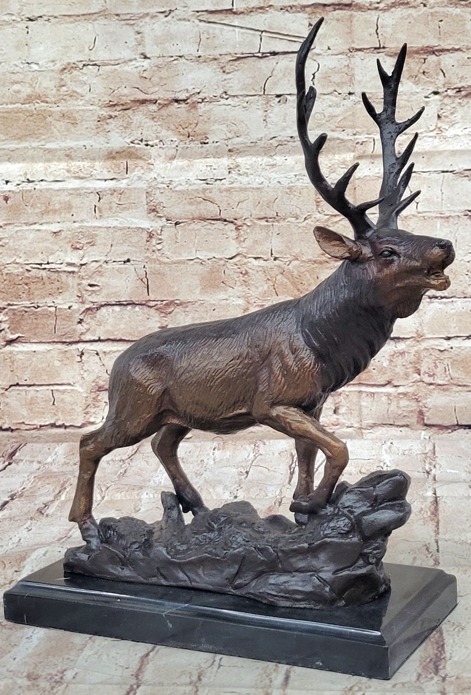 Bronze marble statue of a elk with a full rack of antlers, standing on a slanted hill, mounted on a black marble base - Your Western Decor