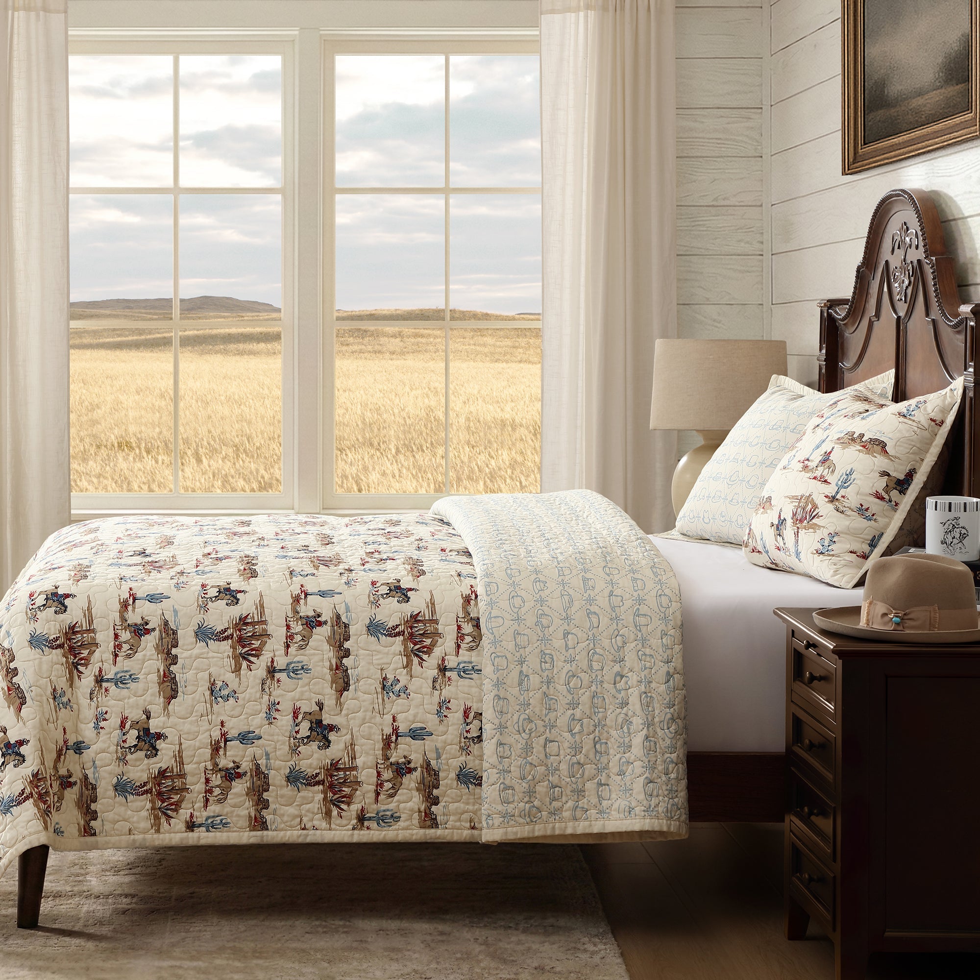 Bedroom with a bed featuring a patterned western cowboy quilt, wooden headboard, and nightstand with a lamp.