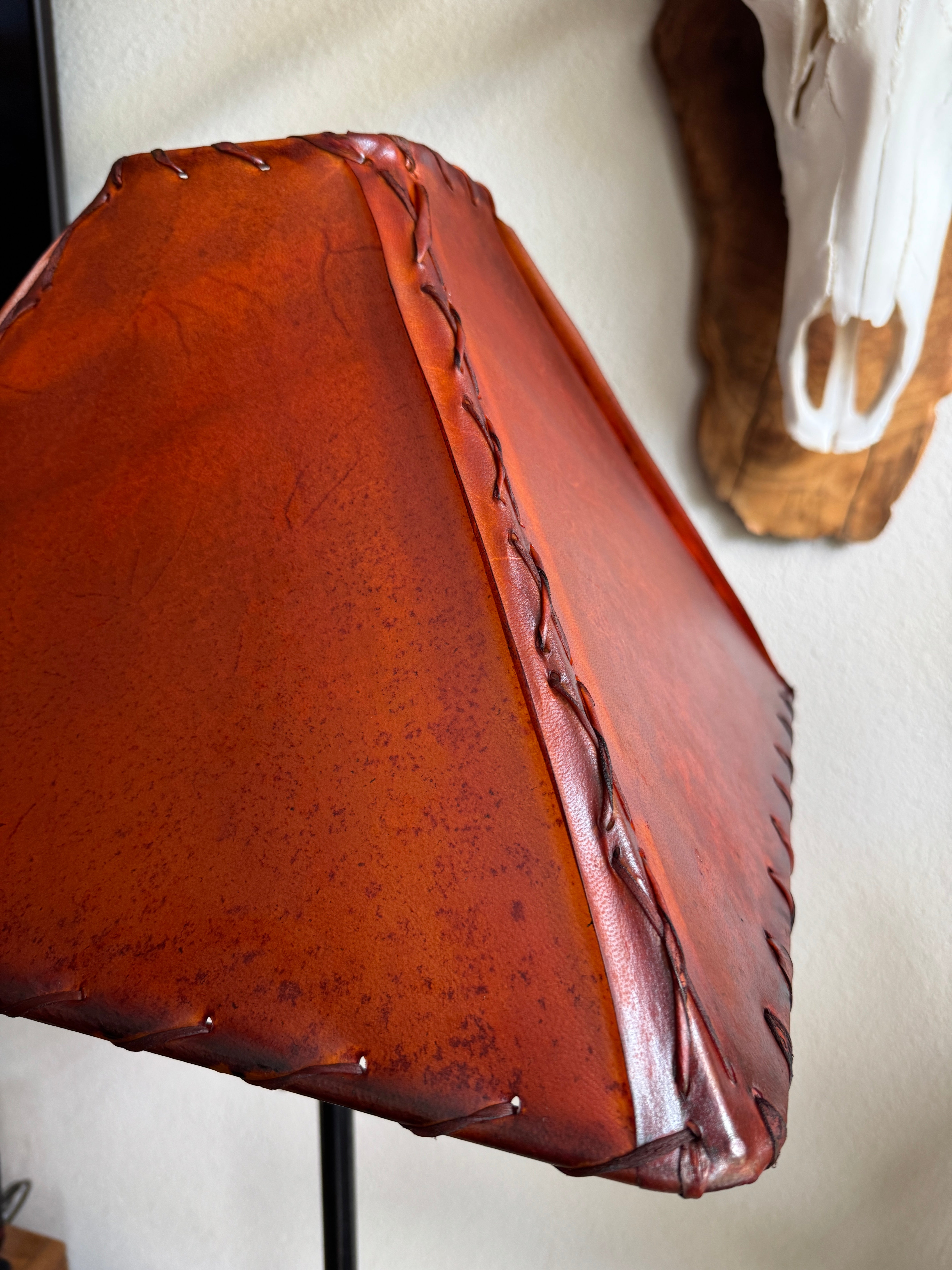 Close up detail of whip stitching on corner of square amber rawhide lamp shade