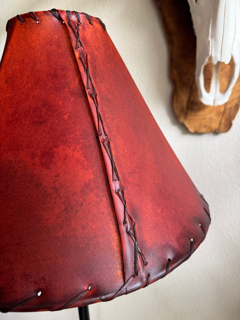 Close up of rawhide whip stitching on round red rawhide lamp shade