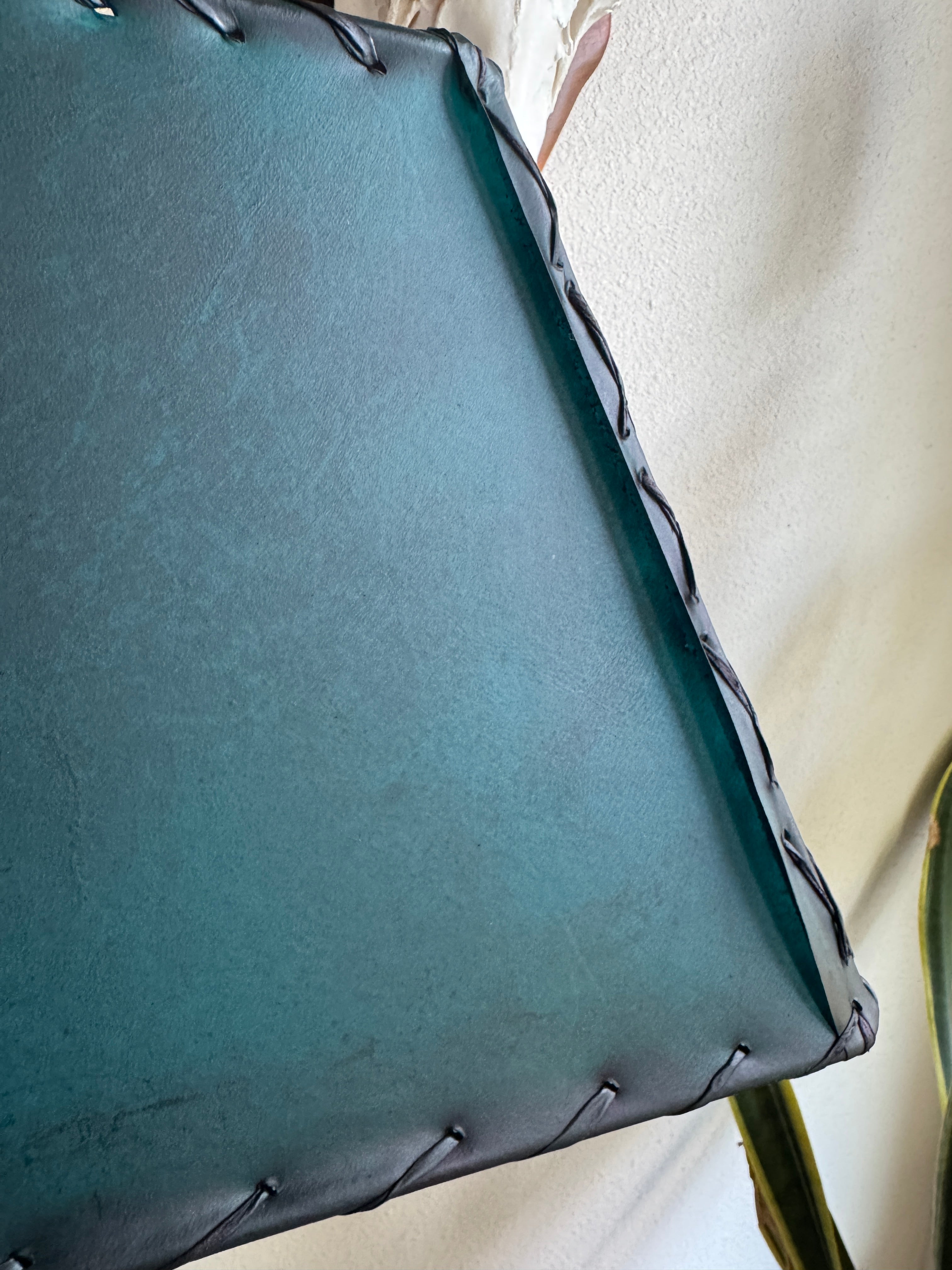 Rustic lodge-style teal rawhide lamp shade whip stitch detail with metal frame construction