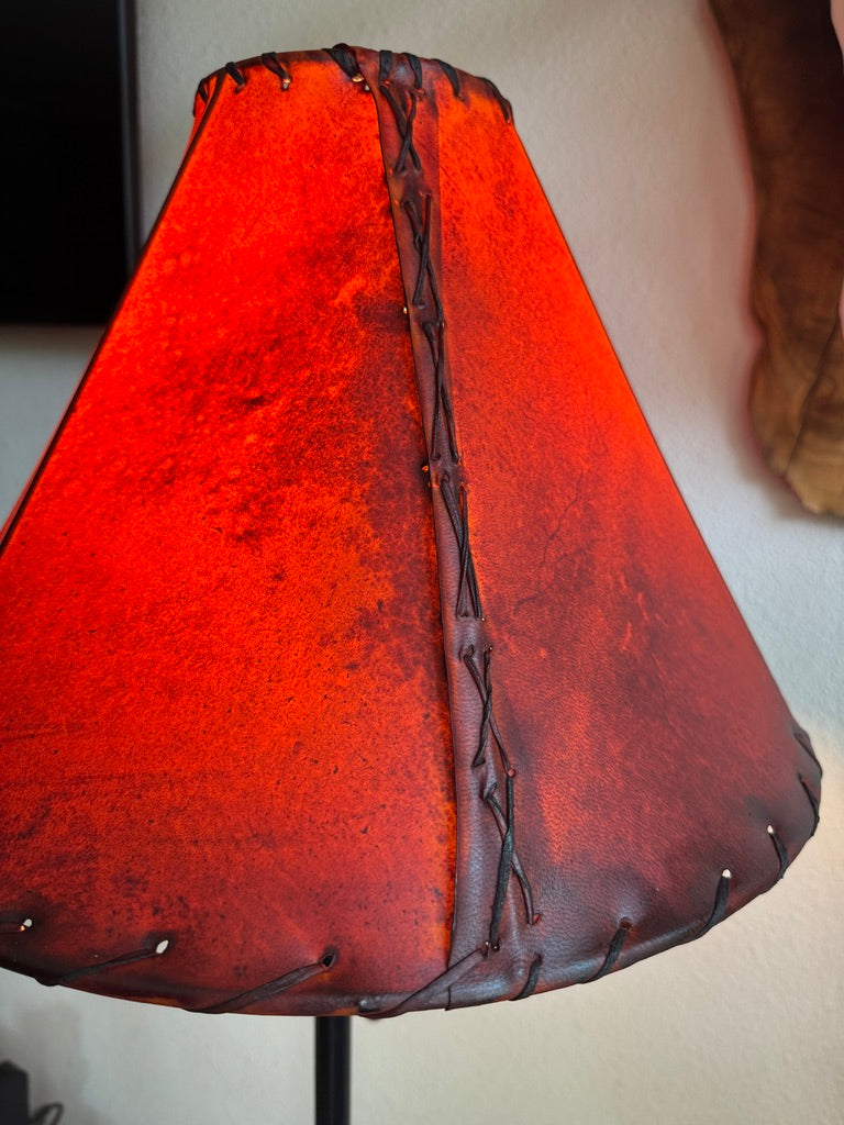 Amber rawhide lamp shade lit showing whip stitch side