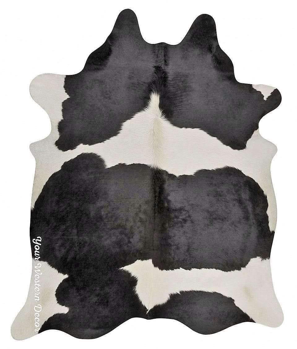 A black and white cowhide rug featuring a natural hair-on pattern.