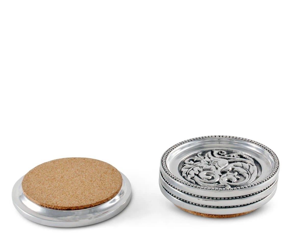 Round aluminum coaster set with cork bottoms. Hammered cactus flower and concho design. Your Western Decor