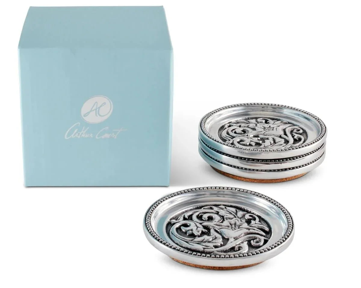 Round aluminum coaster set with cork bottoms. Hammered cactus flower and concho design. Your Western Decor