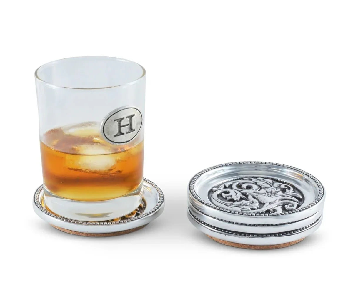 Round aluminum coaster set with cork bottoms. Hammered cactus flower and concho design. Your Western Decor