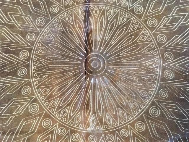 Laser etched detail on black brown cowhide rug -Your Western Decor
