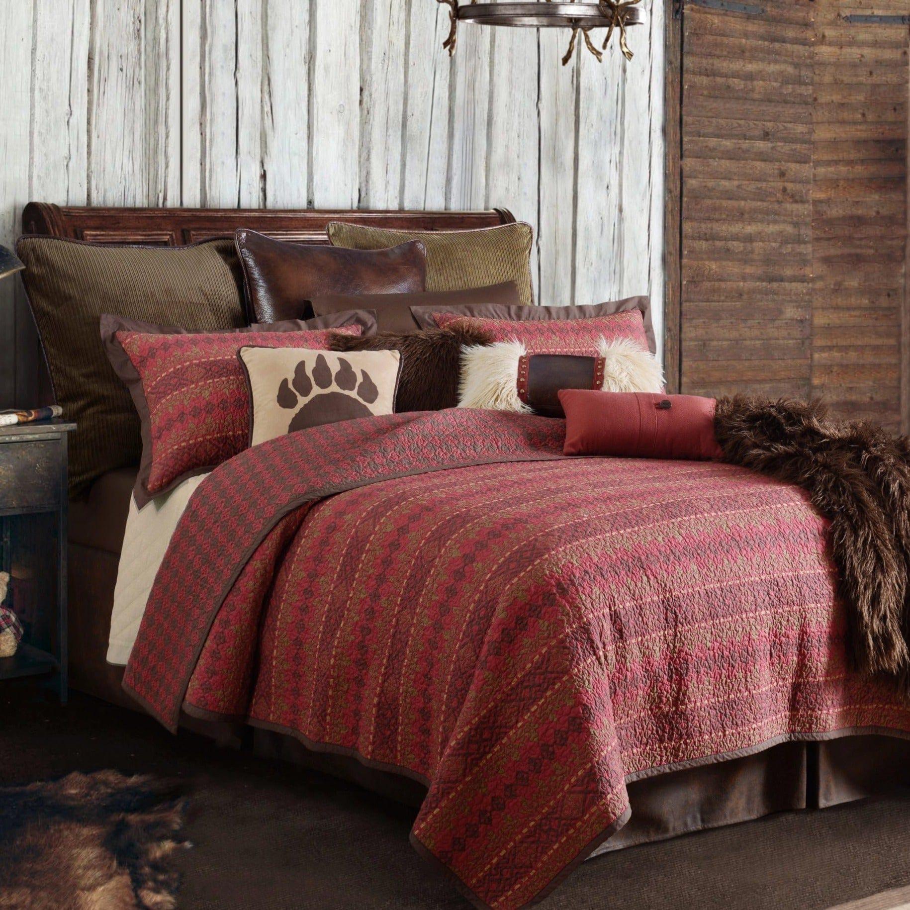 Rushmore reversible quilted bedding set in reds and browns in room with lodge accent pillows and throw