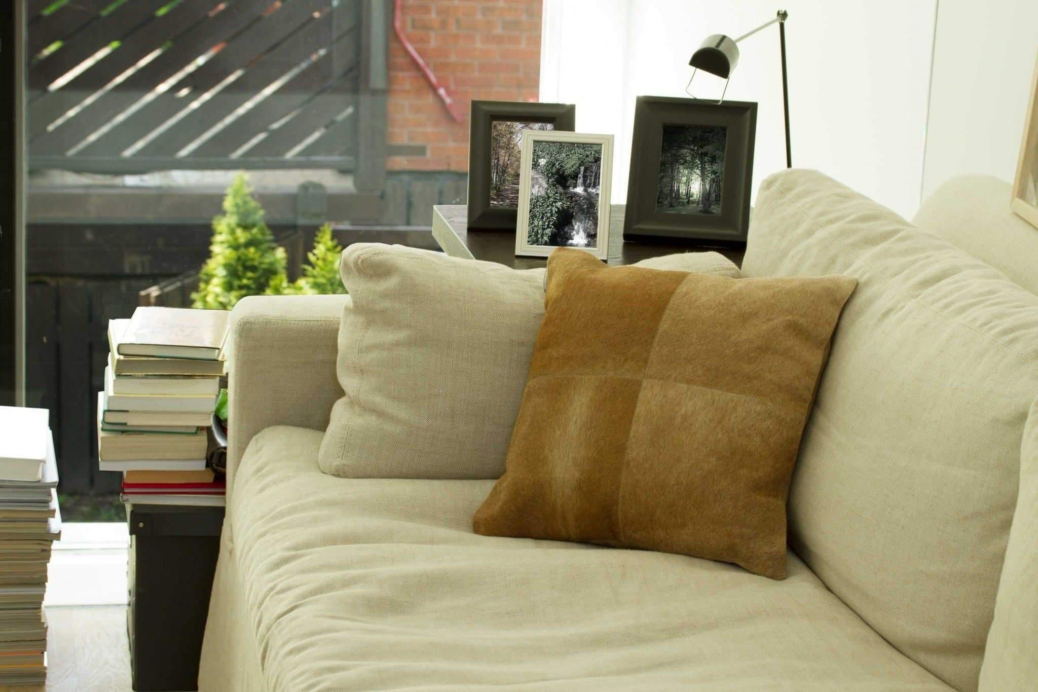 Tan cowhide throw pillow. 4 panel front, micro-suede reverse. Your Western Decor