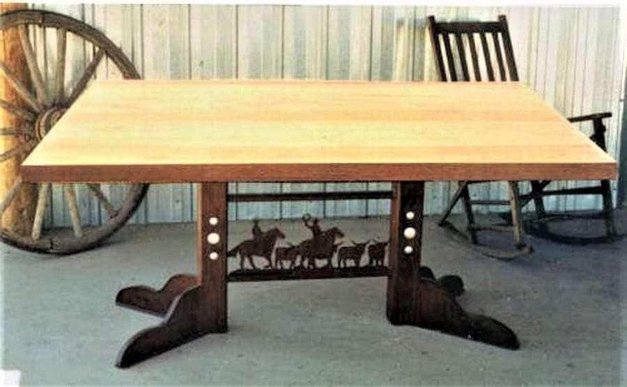 western dining table with iron cowboy base and solid wood top rustic ranch style