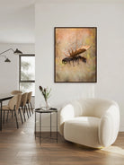 Modern living room with a white armchair, dining table, and framed artwork of a moose - Your Western Decor