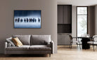 Modern living room with a gray sofa, decorative pillow, and a large painting of horses on the wall - Your Western Decor