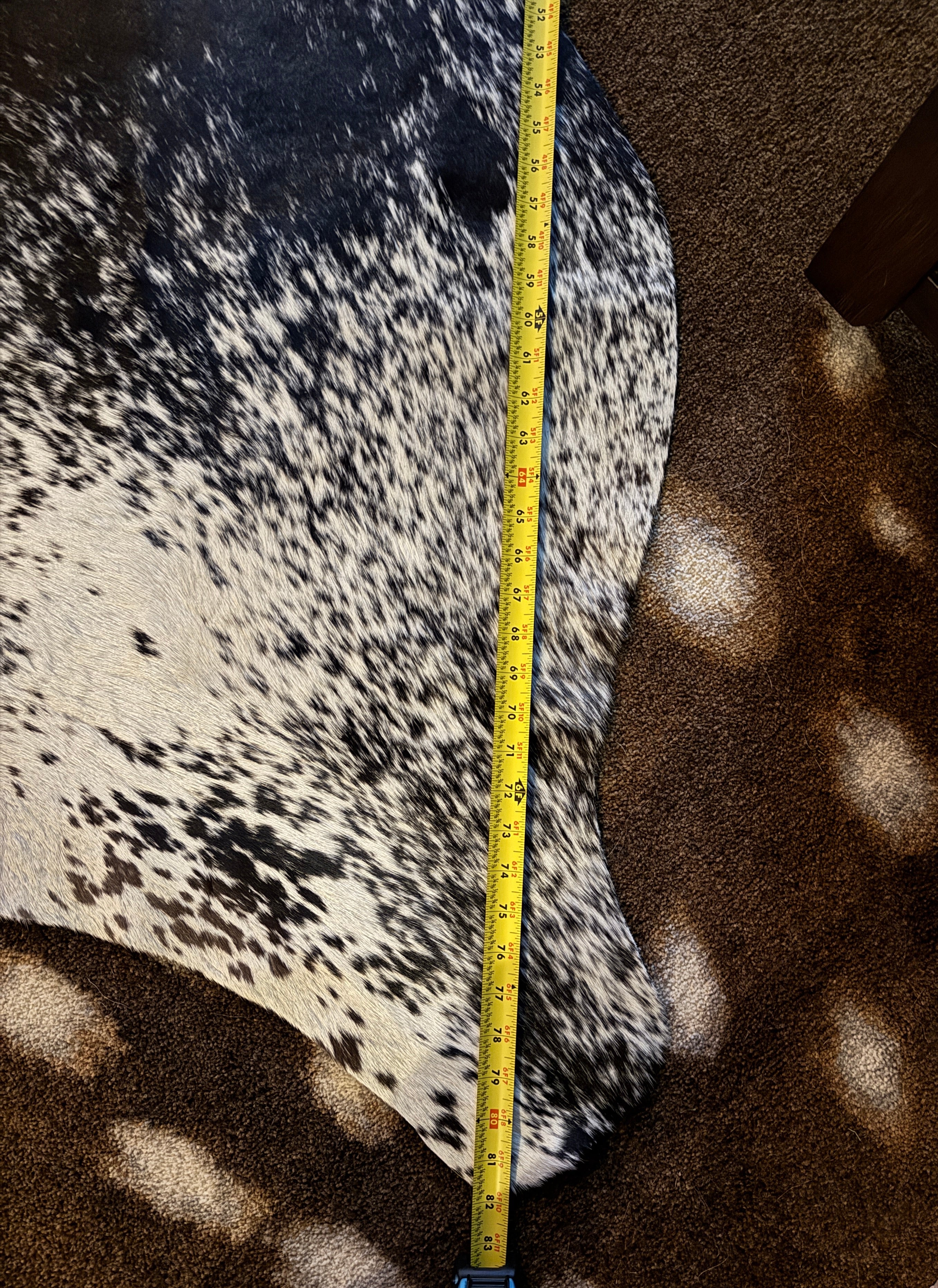 82" measurement of black and white peppered cowhide rug - Your Western Decor