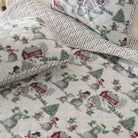 Christmas-themed quilt with snowmen, trees, and red houses on a white background.