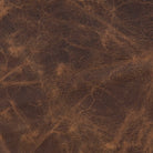 antiqued distressed leather upholstery detail on luxury western swivel chair