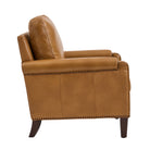 Side profile of Carson camel Leather chair highlighting arm design, nailhead trim and solid wood legs
