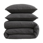 Dark gray textured comforter and pillows on a white background