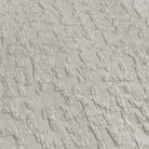 Close-up of textured light gray fabric with a diamond pattern