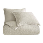 Textured beige quilt and pillow set on a white background