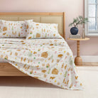 Bed with gingerbread patterned bedding and pillows in a bedroom setting