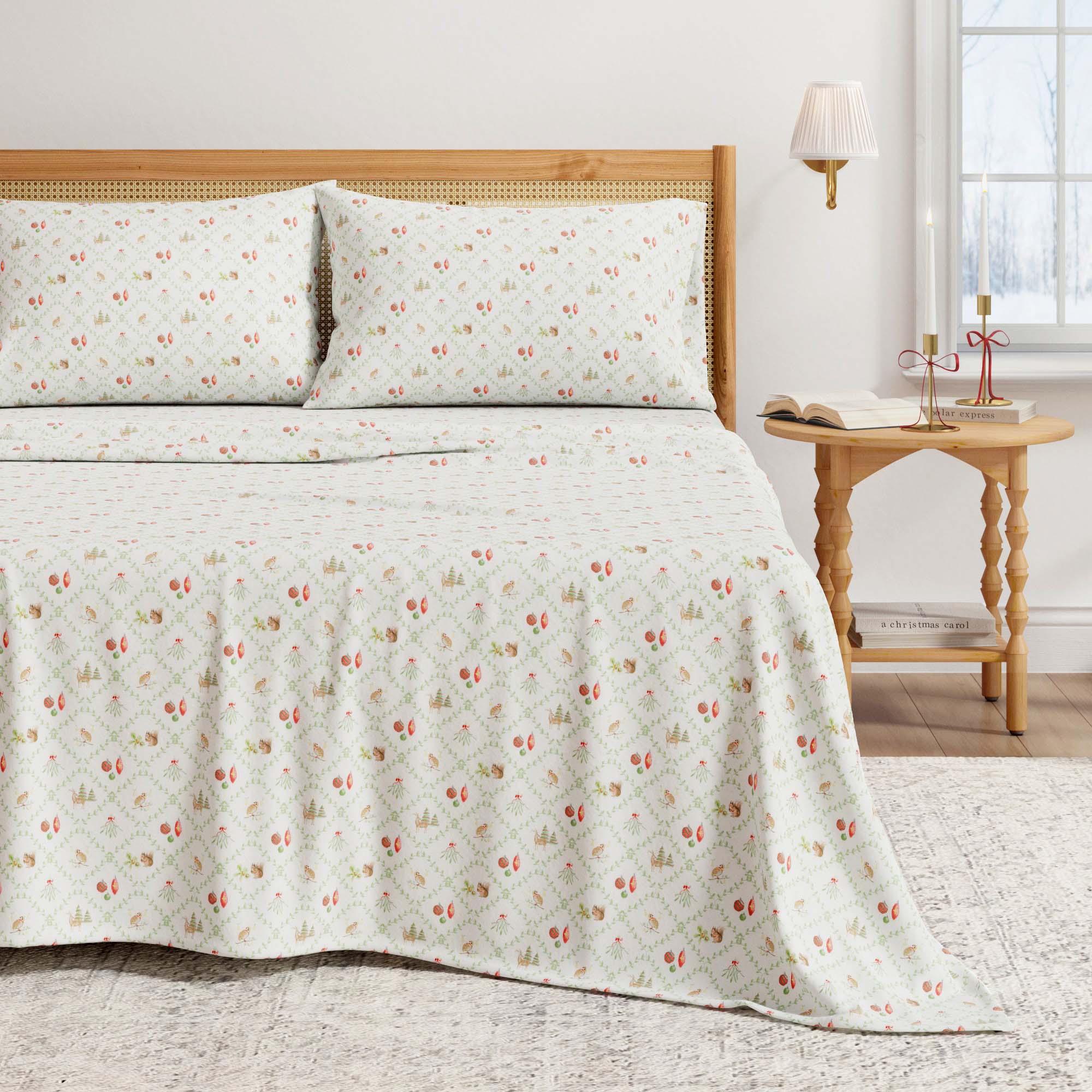 Holiday Floral lattice patterned bedspread on a bed with a wooden headboard and side table.