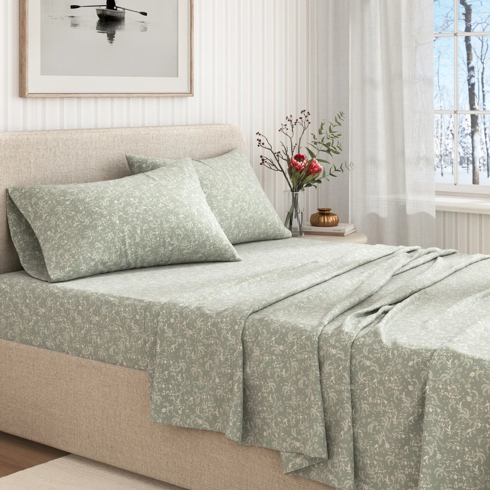 Bed with green floral bedding in a bright bedroom