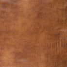 Premium pebble-grain leather in warm saddle brown featuring natural character markings, soft texture, and authentic color variation.