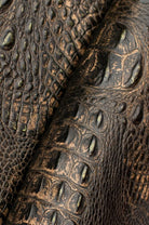 Close up of Midas Touch Sacred Scarah croc embossed leather with gold copper metallic 