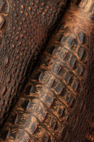 Detail of two-tone croc embossed leather with metallic hints 
