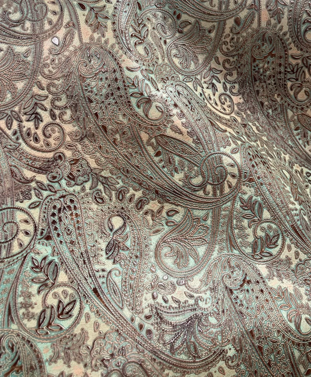 Close up of paisley turquoise chocolate paisley embossed leather hide 